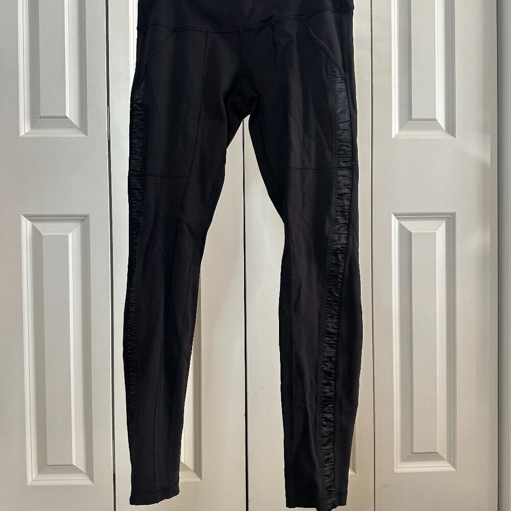 Lululemon size 10 black leggings with satin detail along legs